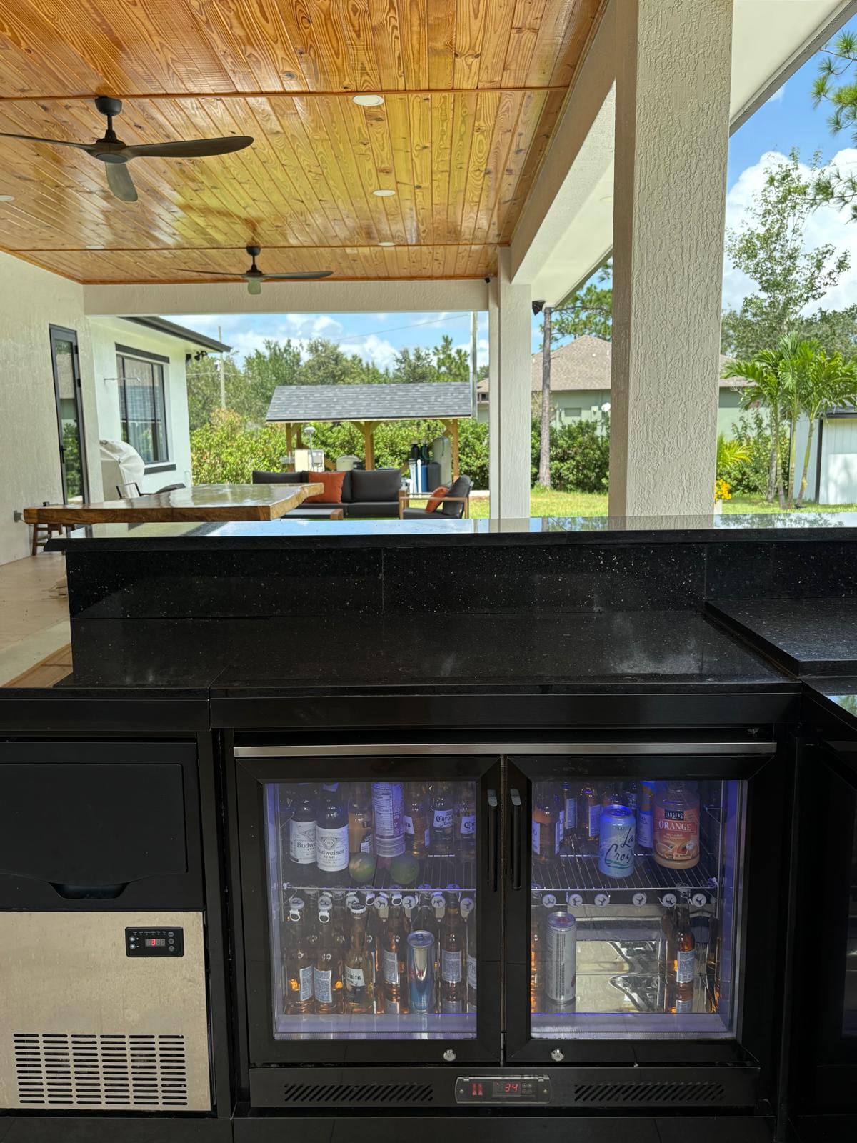 Outdoor kitchen interior under wood-beam pergola