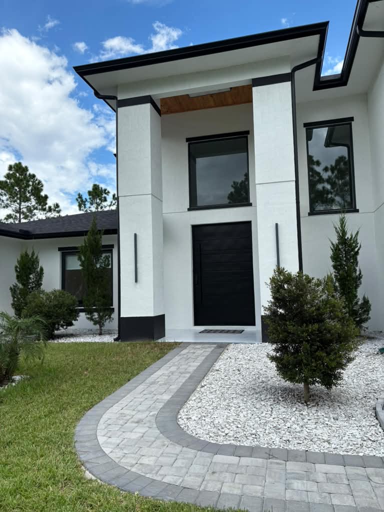 Modern house entrance with curved paver entry walkway